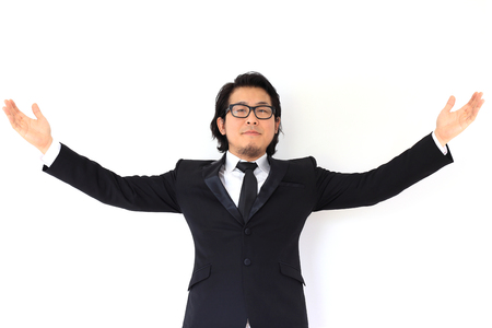 Asian businessman standing with open armsの写真素材