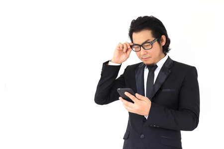 The businessman reading message from a smartphone.の写真素材