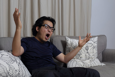 The Asian man relaxing in living room.の写真素材