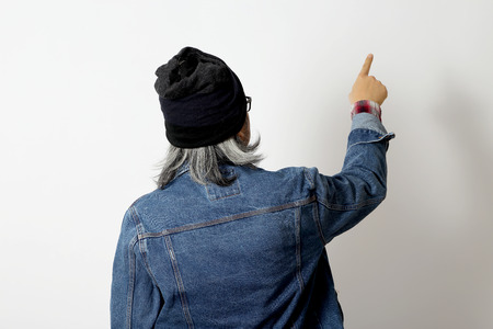 The Asian man with denim shirt and beanie standing on the white background.の写真素材
