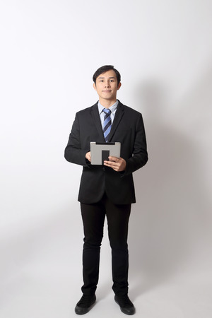 The Asian businessman on the white background.の写真素材