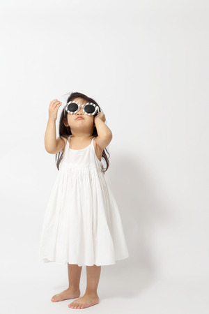 The little Asian girl on the white background.の写真素材