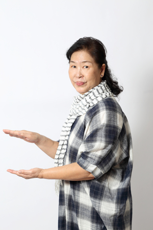 The elder Asian woman on the white background.の写真素材