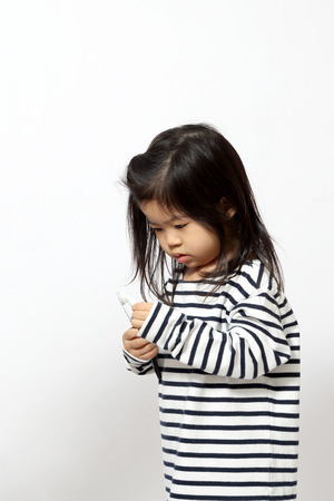 The little Asian girl on the white background.の写真素材