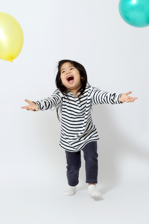 The little Asian girl on the white background.の写真素材