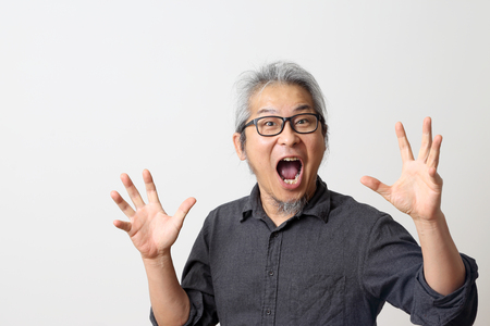The adult Asian man on the white background.の写真素材