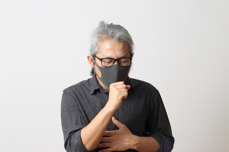 The adult Asian man on the white background.の写真素材