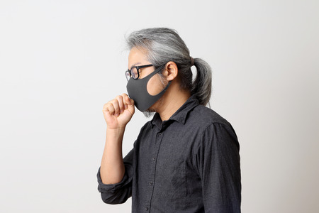 The adult Asian man on the white background.の写真素材