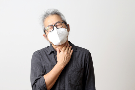 The adult Asian man on the white background.の写真素材