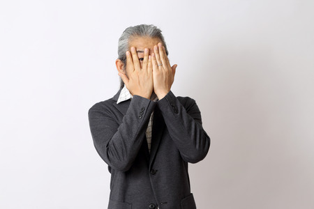 The Asian man closing his eyes.の写真素材