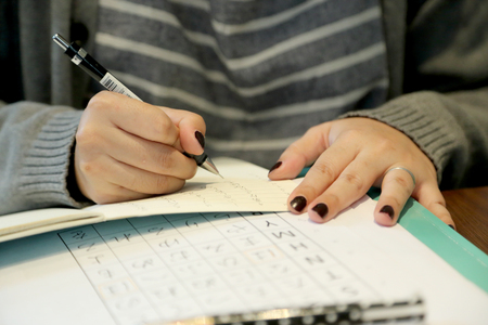 The Asian woman learning japanese language in the coffee shop.
