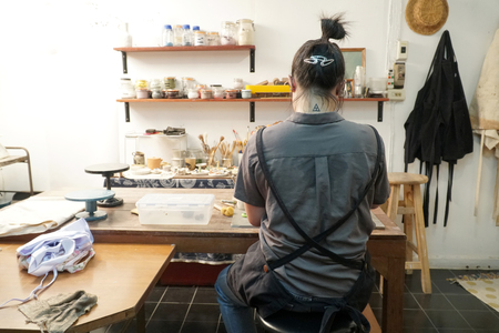 The Asian woman doing craft design works.