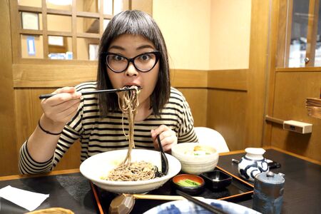 The Asian woman eating ramen.の写真素材