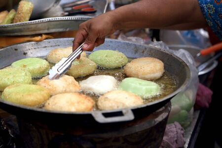 Bangkok, Thailand -February 10, 2013: Thai desserts cooked in the hot oil.のeditorial素材