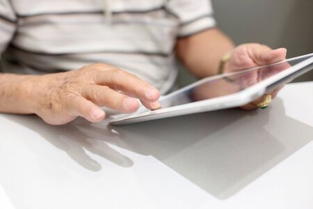 The Asian elder man using tablet.の写真素材