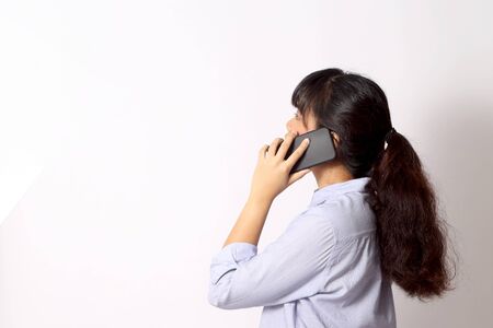 The Asian woman posing on the white background.の写真素材