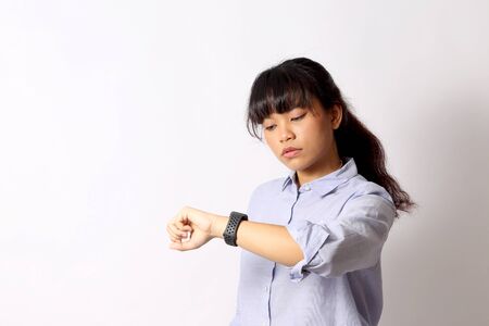 The Asian woman posing on the white background.の写真素材