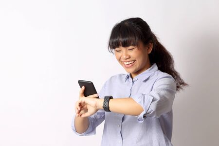 The Asian woman posing on the white background.の写真素材