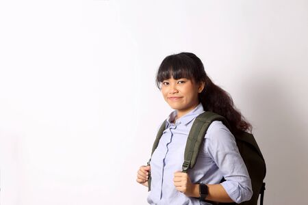 The Asian woman posing on the white background.