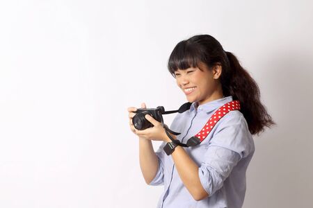 The Asian woman posing on the white background.