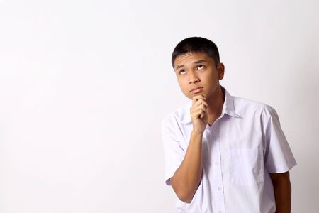 The young Thai student boy on the white background.の写真素材