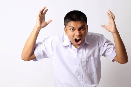 The young Thai student boy on the white background.の写真素材