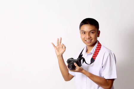 The young Thai student boy on the white background.