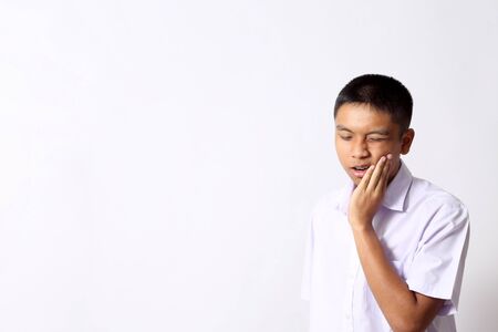 The young Thai student boy on the white background.の写真素材