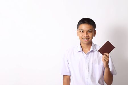 The young Thai student boy on the white background.の写真素材