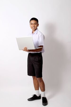 The young Thai student boy on the white background.の写真素材