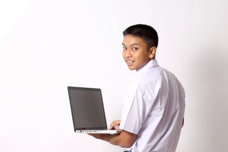 The young Thai student boy on the white background.の写真素材