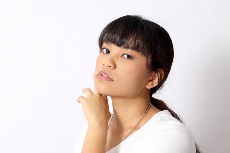 The Asian woman portrait on the white background.