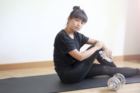 The Asian woman workout in the house.の写真素材