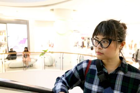The Asian woman using escalator.