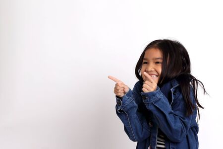 The Asian girl standing on the white background.の写真素材