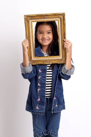 The Asian girl standing on the white background.