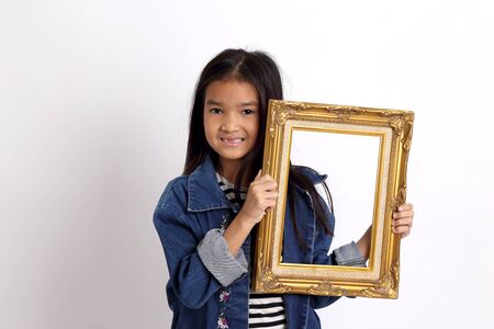 The Asian girl standing on the white background.の写真素材