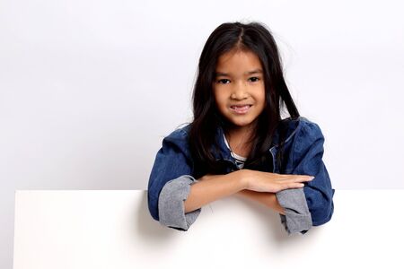 The Asian girl standing on the white background.の写真素材
