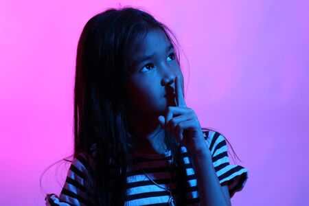 The Asian girl posing in the color gel light.の写真素材