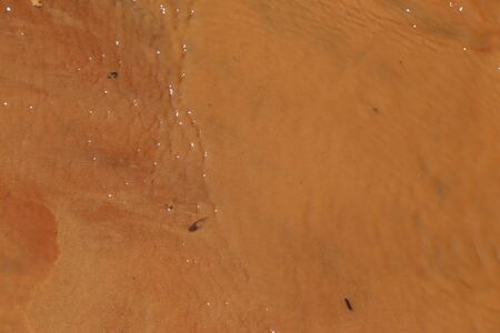 The water flow on the red sand.の写真素材