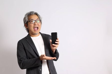 The adult Asian man on the white background.の写真素材