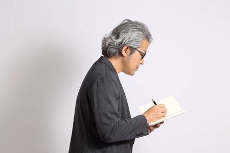 The adult Asian man on the white background.の写真素材