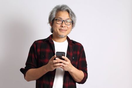 The adult Asian man on the white background.の写真素材