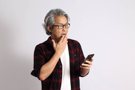 The adult Asian man on the white background.