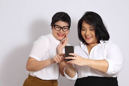 Two Asian women on the white background.
