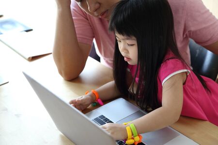 The Asian girl with laptop.