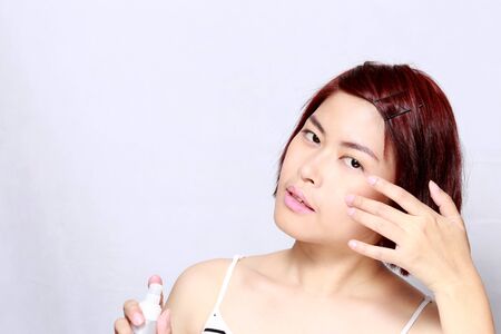 The Asian woman's portrait on the white background.の写真素材