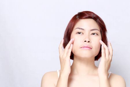 The Asian woman's portrait on the white background.の写真素材