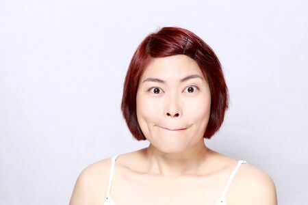 The Asian woman's portrait on the white background.の写真素材