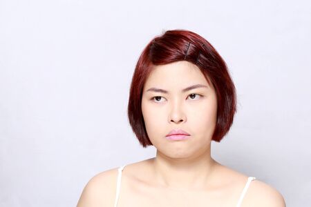 The Asian woman's portrait on the white background.の写真素材